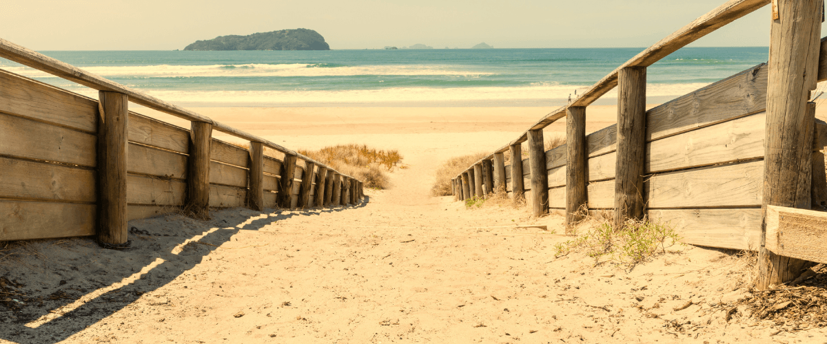 Sandy path leading to Moturiki Island beach and the Pacific Ocean, Mount Maunganui area — The Gold House® precious metals, New Zealand