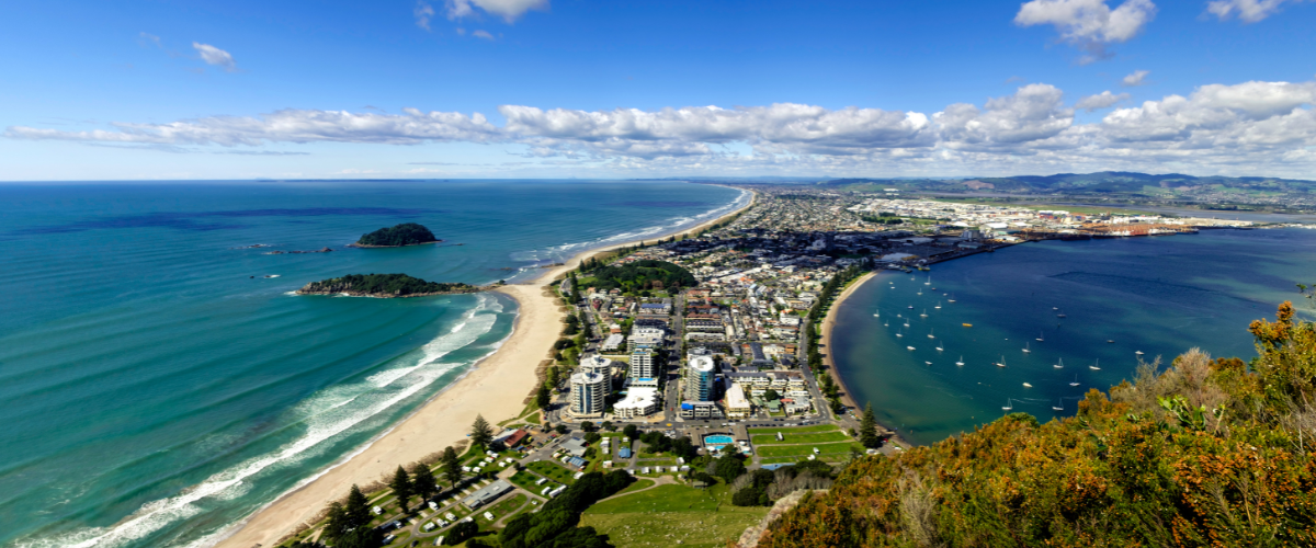 Aerial view of Mount Maunganui, Main Beach, and Tauranga Harbour — The Gold House® gold bullion products, Bay of Plenty, New Zealand